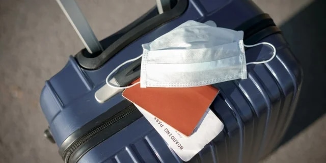 mask on top of a suitcase