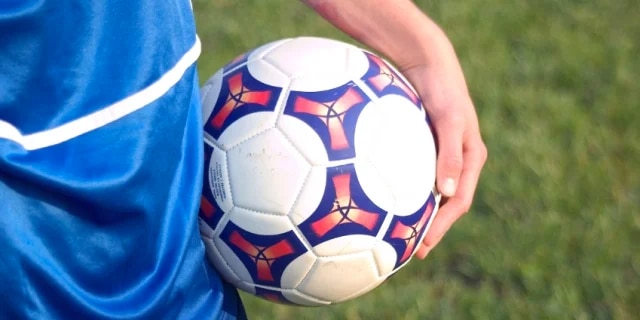 person holding soccer ball